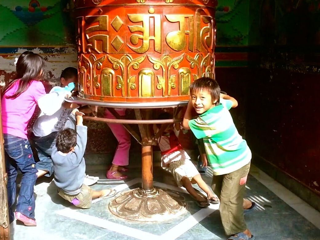 Children of Nepal - Playing on Prayer Wheel - God Dieux Photography